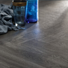 Modern Interior Design with Dark Wood Flooring, Glassware, and Blue Decorative Elements