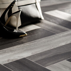 Modern Black and White Herringbone Flooring with Stylish High Heels and Designer Handbag