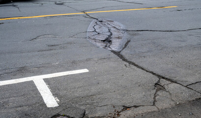 A tar patch on an asphalt road