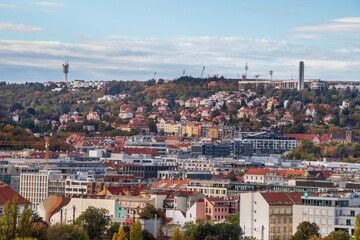 view of Prague in autumn: houses with red roofs, old and new buildings, Prague in October, view...