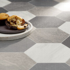 Gray and White Hexagonal Marble Tile Flooring with Muffins on a Plate in a Modern Interior Setting