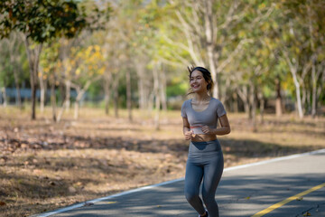 A woman is running on a path in a park