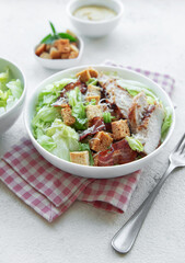 A bowl  of  Caesar salad
