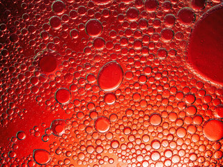 Abstract Background Red oil Macro Colorful artistic of oil drop floating on the water. macro red bubble oil of wallpeper, blood concept