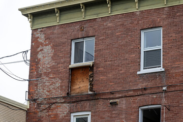 A damaged red brick commercial building