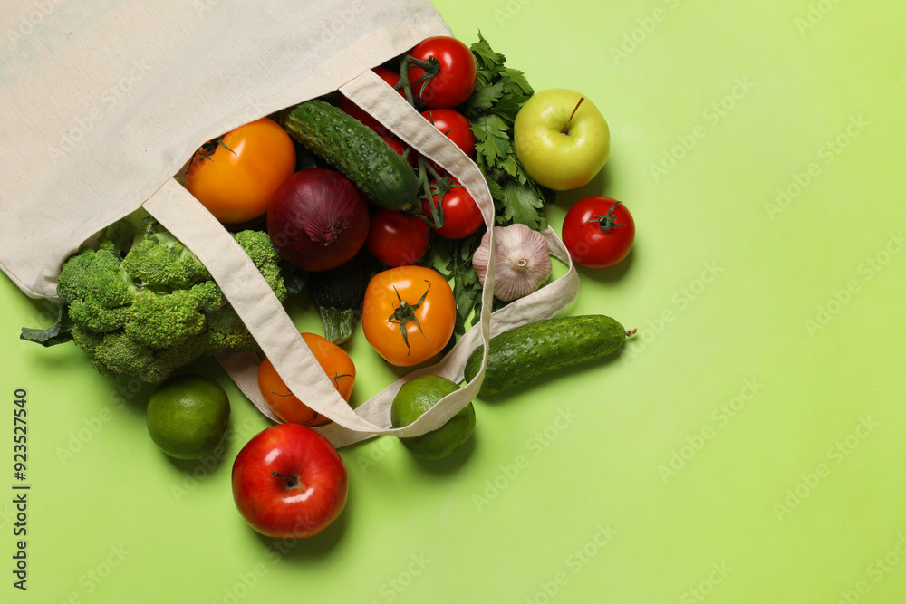 Canvas Prints Delivery of vegetarian products. Bag with different vegetables and fruits on green background, top view. Space for text