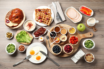 Different meals served for breakfast on wooden table, flat lay