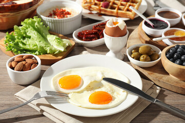 Different meals served for breakfast on wooden table