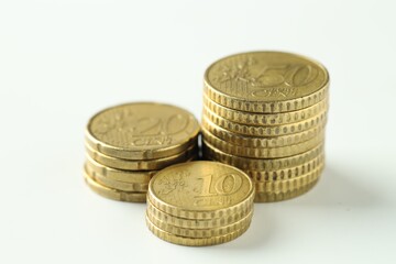 Stacked euro coins on white background, closeup