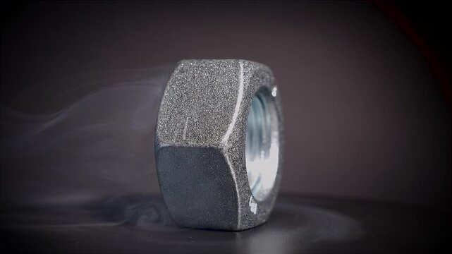 Spinning dice with black background surrounded by smoke