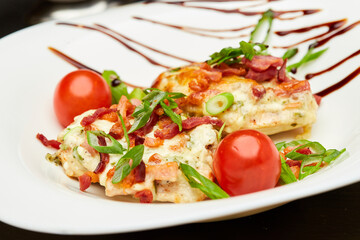 Delicious chicken breast with bacon, fresh tomatoes, and herbs, for gourmet meal presentations