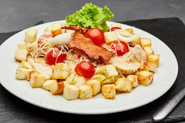 Fresh Caesar salad with cherry tomatoes, crispy bacon, and parmesan cheese, perfect for a light meal