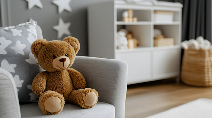 teddy bear sitting on an armchair in scandinavian style baby room; simple bright grey cozy insides of a children bedroom; copy space