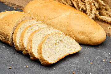 Freshly baked white bread loaf, sliced and ready to serve, perfect for sandwiches and breakfast