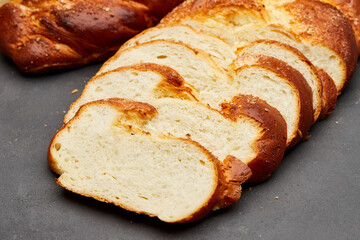Braided sweet bread loaf sliced, showcasing its golden crust and soft, fluffy interior