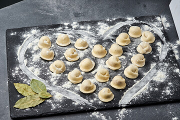 Heart-shaped arrangement of handmade meat dumplings, capturing the essence of traditional cooking