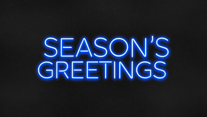 seasons greetings blue neon lettering on plain dark black background