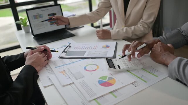 Team analyzing financial data in business meeting for strategy development