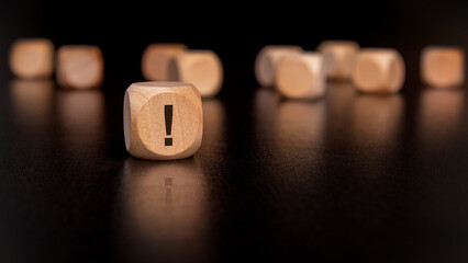 concentrate on a wooden block featuring an exclamation mark symbol, signifying urgency