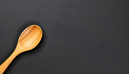 Wooden spoon and fork from top view on black slate with space for text isolated with white highlights, png