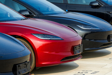 Fototapeta premium A row of brand new new energy electric cars parked in an outdoor parking lot