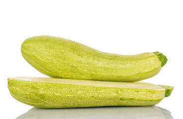 One whole and half ripe zucchini, macro, isolated on white background.