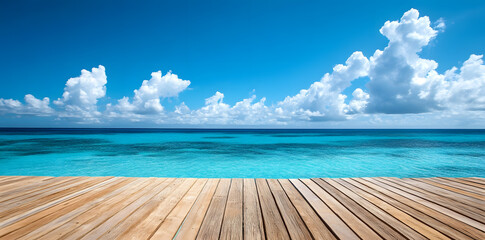 Fototapeta premium Wooden deck in front of clear blue ocean with clouds in the sky