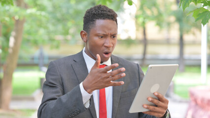 Portrait of African Businessman with Loss on Tablet