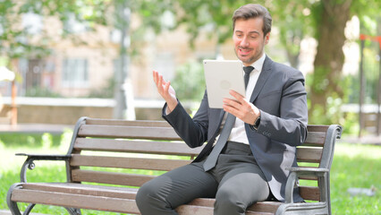 Fototapeta premium Middle Aged Businessman Doing Video Chat on Tablet Outdoor