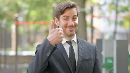 Portrait of Young Businessman with Thumbs Up Outdoor