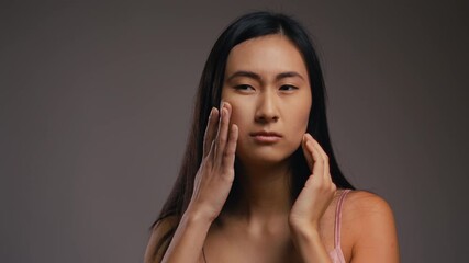 Young Asian woman upset with dry face skin and crying, first signs of ageing