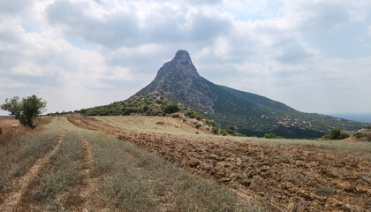 Obraz premium A view from the east of a rocky peaked mountain in the south of Guveloglu village in the Yüreğir district of Adana province