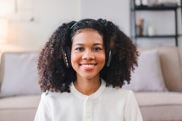 Fototapeta premium Smiling African American Woman Listening to Music with Headphones.