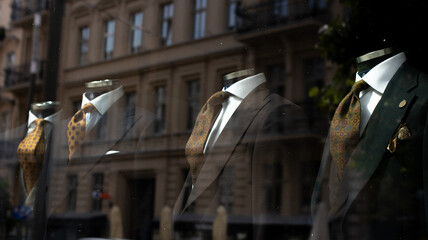 Elegant Tailored Suits Are Beautifully Displayed in the Storefront Showcase for All To See