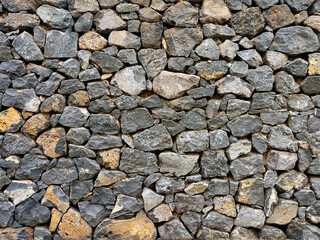 Background of stone wall texture. Old texture of granite stone wall surface.