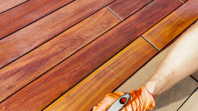 Hardwood decking, deck oil application with painting brush
