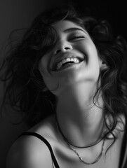 Joyful Young Woman Smiling in Black and White Portrait