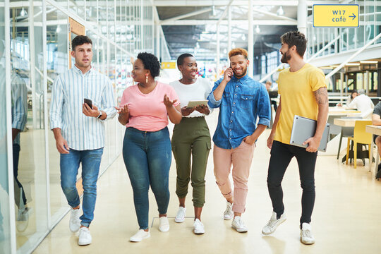 Walking, group and business people in modern office, technology and internet with connection. App, graphic designers and employees with tablet, smartphone and conversation with network and diversity