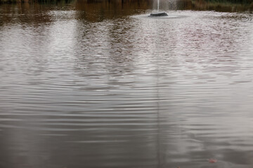 Quiet water with a fountain in a serene setting autumn in Stromovka park, Prague, Czech republic