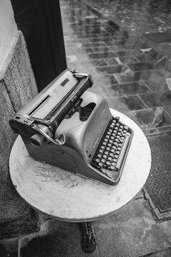 Vintage antique typewriter in the street in black and white