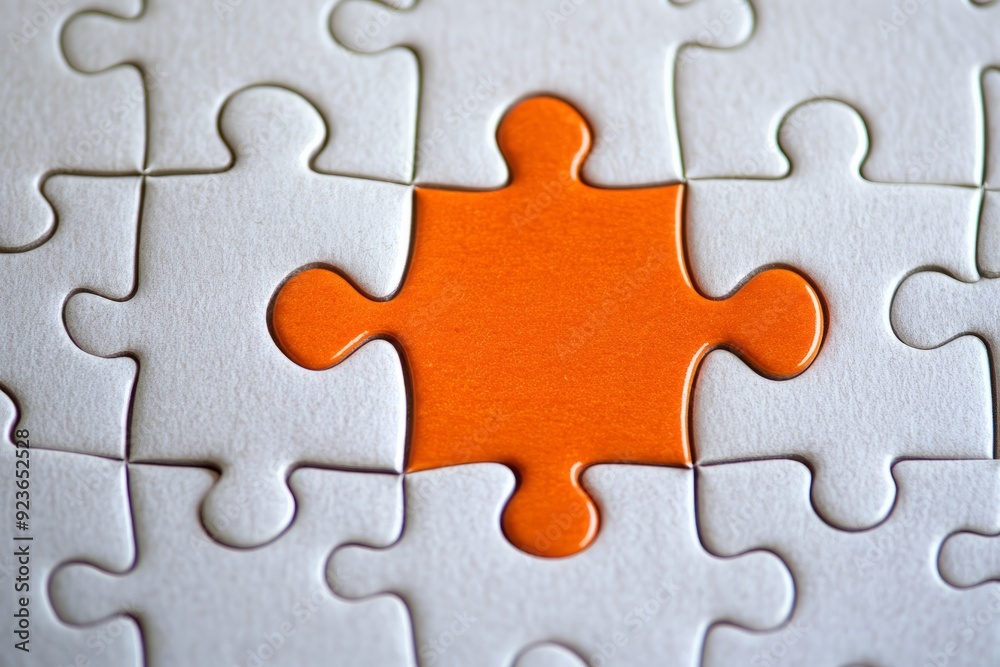 Wall mural Picture of an orange puzzle piece that fits into a white puzzle. Teamwork, solutions, and problem-solving concepts are emphasized