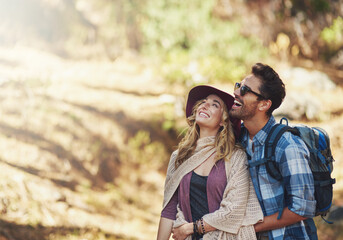 Hug, couple and happy outdoor for hiking in nature on vacation, together and walking in forest for adventure. Man, woman and smile in woods for explore on travel holiday in New Zealand with space.