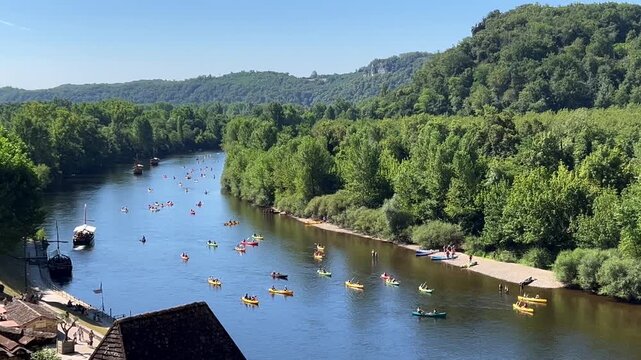 Kayaking at Dordogne river, in La Roque-Gageac, in the Perigord, France. High quality 4k footage
