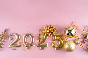 Merry Christmas and Happy New Year 2025 background with golden bauble, Christmas tree balls and decorations, gift bow, serpentine, 2025 golden candles numbers, flat lay top view copy space