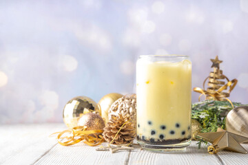 Christmas holiday eggnog boba milk tea cocktail. Trendy eggnog bubble tea or latte with New year and Xmas decorated background, copy space
