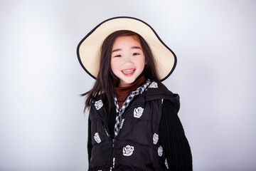 Asian little girl wearing a straw hat on white background