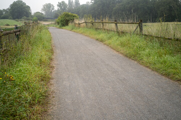 path with fences between fields