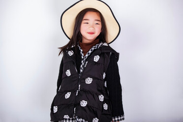 Asian little girl wearing a straw hat on white background