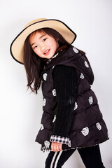 Asian little girl wearing a straw hat on white background