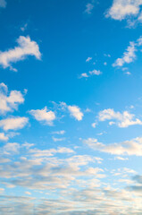 Obraz premium Blue sky landscape with dramatic sundown clouds lit by evening sunset light